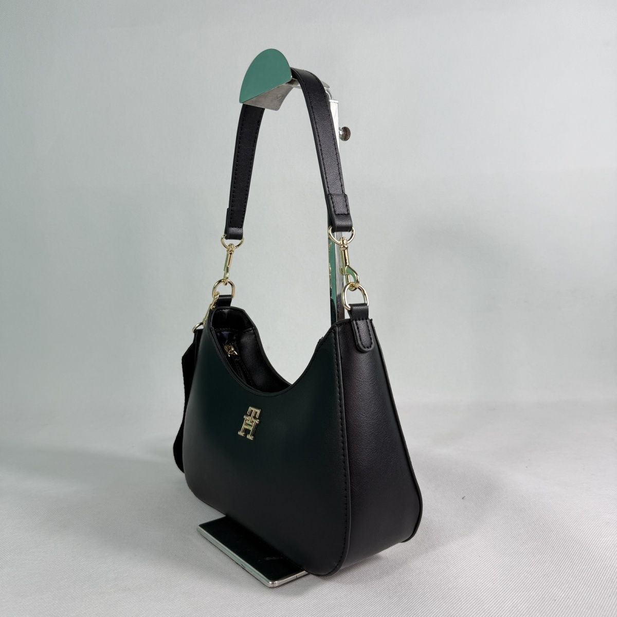 Tommy Hilfiger – TH მონოგრამითა და ნახევრადმთვარისებური ფორმით გაფორმებული ტრენდული ჩანთა thumbnail
